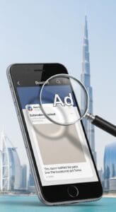 A smartphone displaying an ad under a magnifying glass, set against a backdrop of the Burj Khalifa and Dubai skyline.